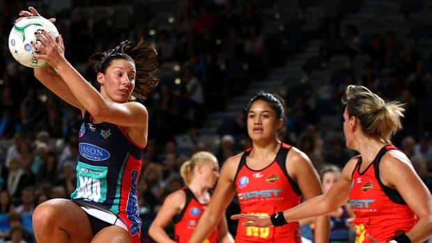 Madison Browne of the Melbourne Vixens (left) leaps to grab a pass in front of two Waikato Bay of Plenty Magic opponents at Hisense Arena.