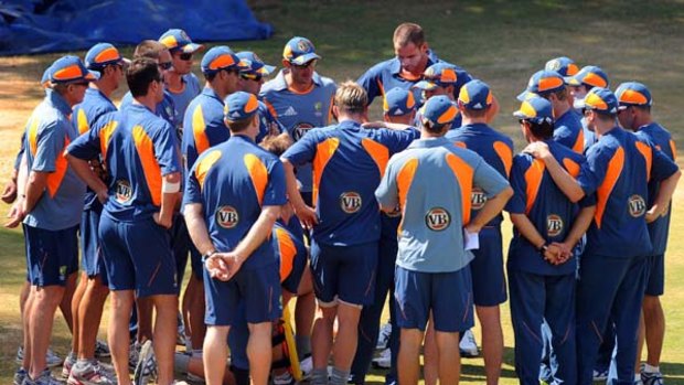 Australian cricketers attend a team meeting during a training session at the National Cricket Academy in Bangalore yesterday.