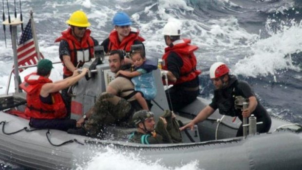 Sailors from the USS Vandegrift assist in the rescue of the Kaufman family 1400 kilometres off the coast of Mexico.