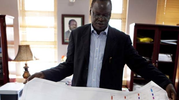 Dr. Daniel Wani, Undersecretary for the Ministry of Housing and Physical Planning in the Government of South Sudan, explains a map of Juba in the shape of an rhino.