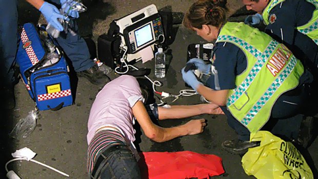 Paramedics attend a collapsed schoolie at this year's end of year celebrations at Surfers Paradise.