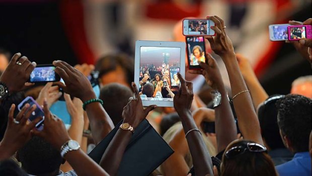 Screen queen &#8230; Michelle Obama is filmed and recorded by supporters at a high school in Florida while on the campaign trail.