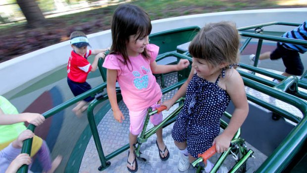 Paige Caruana, 5, enjoys the All-Abilities playground with her sister Taylor Caruana, 7..