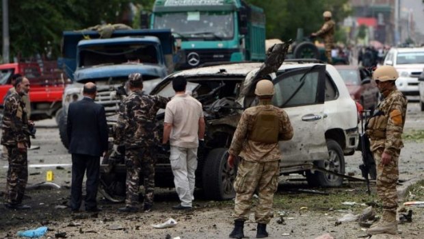 A damaged car at the site of a suicide car bomb attack on the convoy of Afghan presidential candidate Abdullah Abdullah.