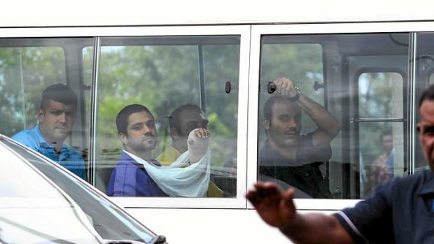 Injured asylum seekers arrive at the local hospital just before a Fairfax photographer was detained and their camera taken.