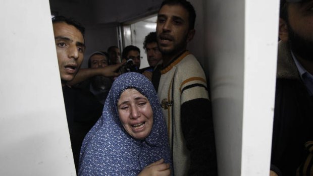 A relative grieves at the hospital in Gaza City after the deaths of one family in an Israeli air strike.