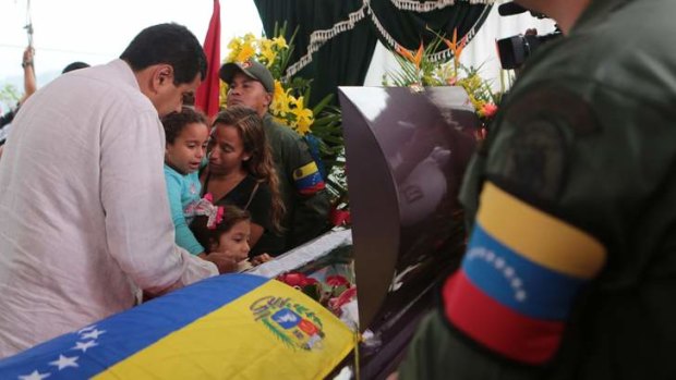 Man of the people: Venezuela's President-elect Nicolas Maduro comforts the family of Jose Luis Ponce, a supporter killed in post-election violence.
