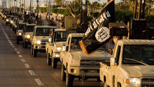 Members of the Islamic State (IS) jihadist group parading in a street in Libya's coastal city of Sirte.