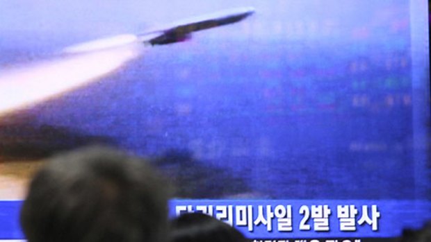 Nervous times ... South Koreans watch file television images of a  North Korean missile launch.