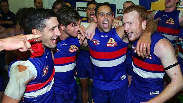 That winning feeling: Western Bulldogs players celebrate their victory over the Brisbane Lions last weekend.