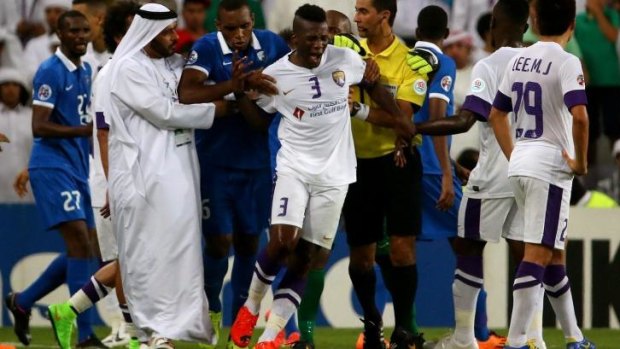 UAE's al-Ain forward Asamoah Gyan reacts after receiving his marching orders.