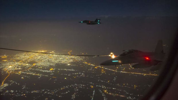 Two Australian FA-18F Super Hornet aircraft conduct air-to-air refuelling during their first mission in Iraq.