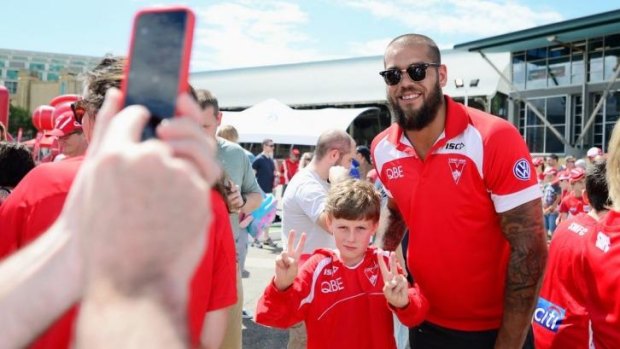 Crowd pleaser: Lance Franklin poses for a photo with a young Swans supporter.