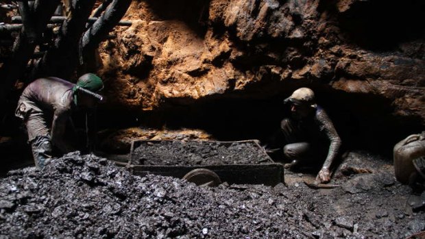 "I have never seen a school": Gayasuddin, with a colleague, emerges from the rat-hole mine with a full cartload of coal.