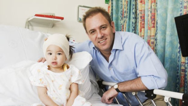 Fitness message ... Dr Jonny Taitz with 23-month-old patient Georgia Elfes at the Sydney Children’s Hospital at Randwick