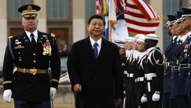 Man of the moment: Chinese Vice-President and expected future leader Xi Jinping reviews an honour guard while visiting the Pentagon.