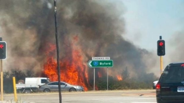 The fire burned through bushland close to the freeway.