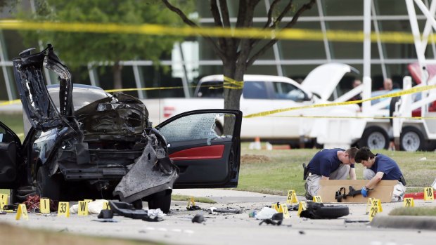 Investigators box up an assault weapon outside the Curtis Culwell Centre in Garland, Texas, after two men were killed in an attack on a provocative contest for Prophet Mohammed cartoons.