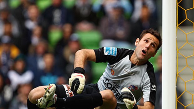 Roar keeper Michael Theoklitos in action against his former club, Melbourne Victory, at AAMI Park on Sunday.