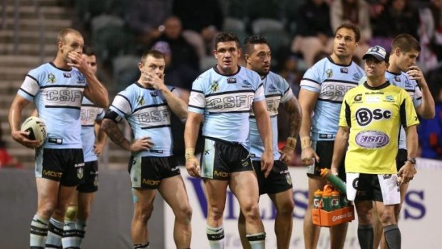 Sharks players await a Dragons conversion at WIN Stadium during their heavy loss last weekend. The club is set to receive another setback with the ASADA investigation getting closer to its conclusion.