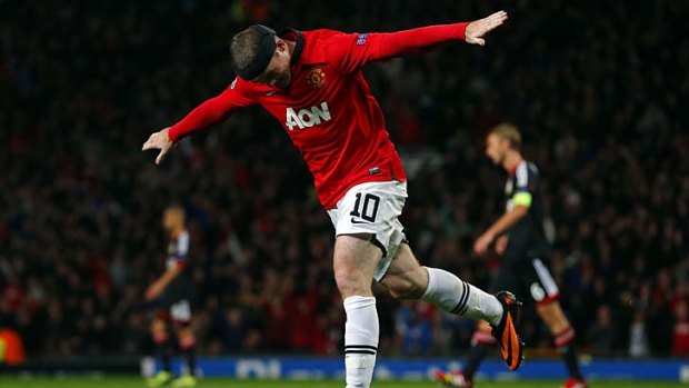 Manchester United's English striker Wayne Rooney celebrates scoring against Bayer Leverkusen.