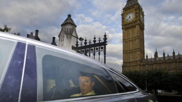 British Prime Minister David Cameron leaves the Houses of Parliament in the back of a car after parliament voted overwhelmingly in favour of joining US-led air strikes on Islamic State targets in Iraq.