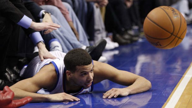 Philadelphia 76ers guard Michael Carter-Williams looks on from the court after he tried to save the ball form going out of bounds against the Milwaukee Bucks.