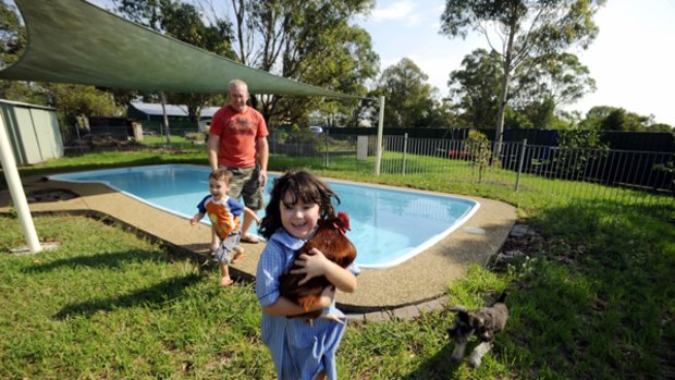 The Devine family from Doonside enjoy their huge backyard with enough room for playing with their dad Matthew and their chickens, dog, pool, cubbyhouse and veggie patch.