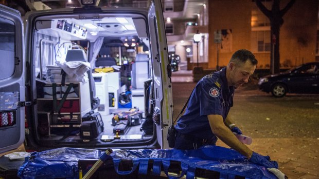 NSW Ambulance paramedic Eugene Roser cleans a trolley.
