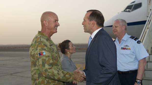 Major-General Craig Orme greets Prime Minister Tony Abbott as he arrives at Al Minhad Air Base, United Arab Emirates.