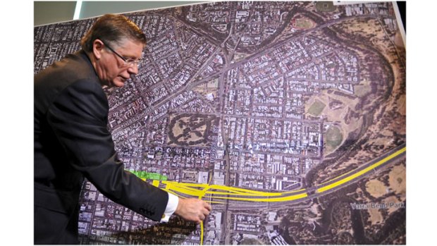 Premier Denis Napthine shows plans for the east-west tunnel.