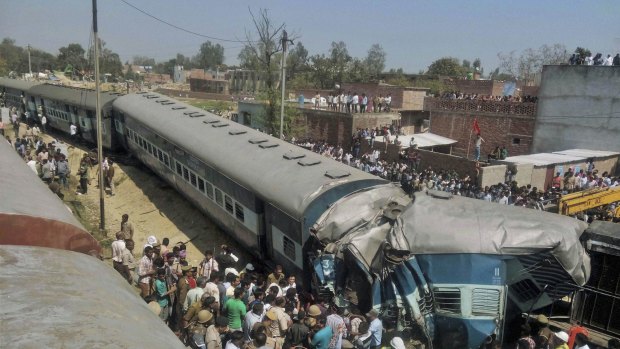 Indian rescue workers gather at the site of a train accident near Bachhrawan village in Uttar Pradesh state, India.