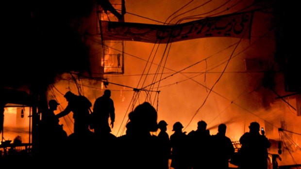 Pakistani firefighters extinguish fire after twin bomb blasts in Lahore.