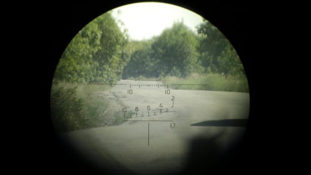 A view through the scope of a sniper rifle belonging to Pro-Russian separatists, showing the road to  Ukraine.