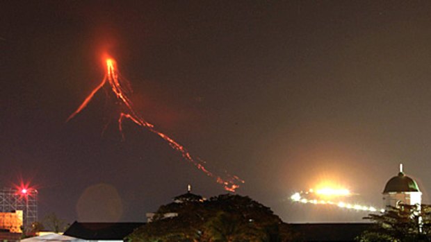 Lava continues to flow down the slopes of the Mayon volcano, seen from Legazpi city, 500 kilometres from Manila in the Philippines.