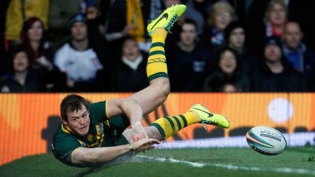 Slip sliding away: Brett Morris eyes an imminent collision with an advertising billboard after scoring a try in Australia's 34-2 World Cup final win over New Zealand.