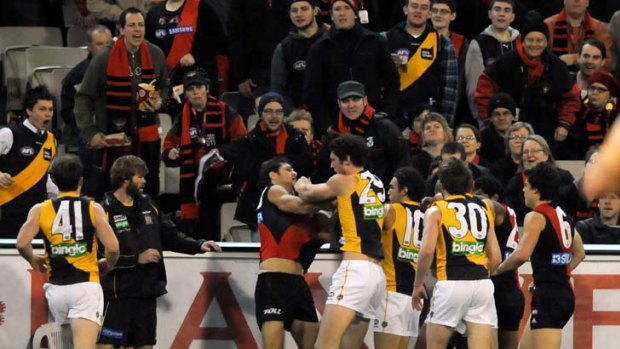 Richmond and Essendon players sort out their differences at quarter time.