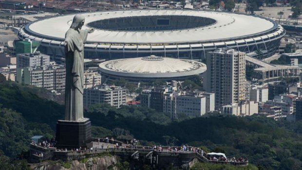 House of pain: Christ the Redeemer overlooks Rio’s Maracana Stadium, scene of Brazil’s darkest hour in 1950, when they were stunned in the World Cup final by Uruguay.