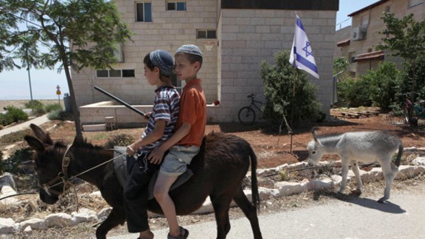 Insisting on "natural growth" ... children ride a donkey in a Jewish settlement near the West Bank Palestinian city of  Ramallah.