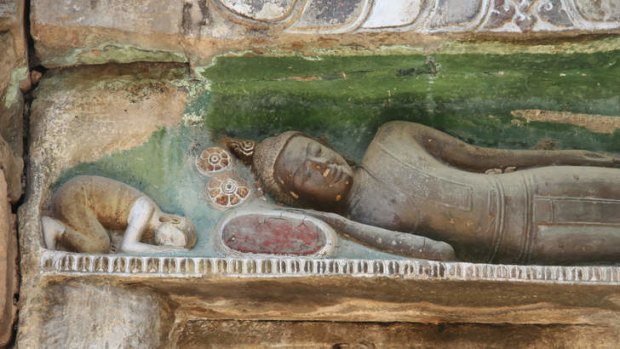 Angkor not: a sleeping Buddha carved in stone at Ta Prohm temple.