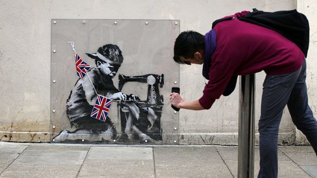 The Banksy mural as seen on the wall of a Poundland store in an area of north London. The mural is scheduled to be sold in Miami this week.