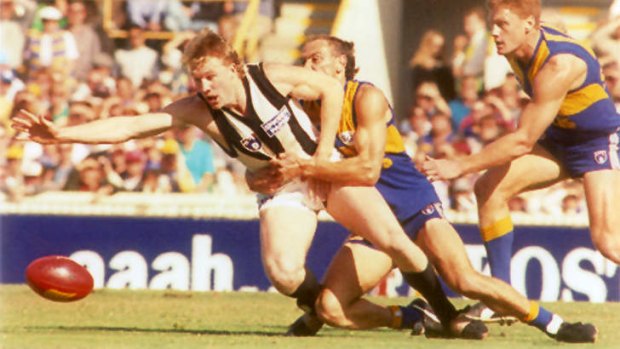 Nathan Buckley tackled by Peter Matera. Eagles coach John Worsfold believes less bench rotation will revive the great one-on-one battles.