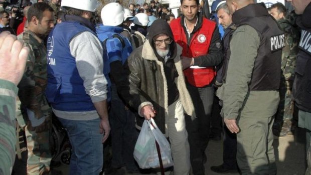 Way out: A man from a besieged area of Homs arrives at an area under government control.