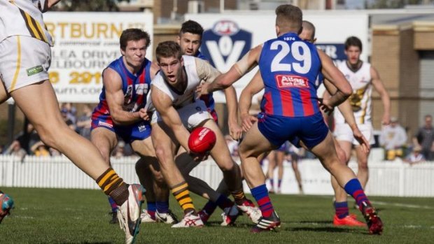Box Hill’s Jordan Kelly is tackled in the qualifying final against Port Melbourne at North Port Oval.
