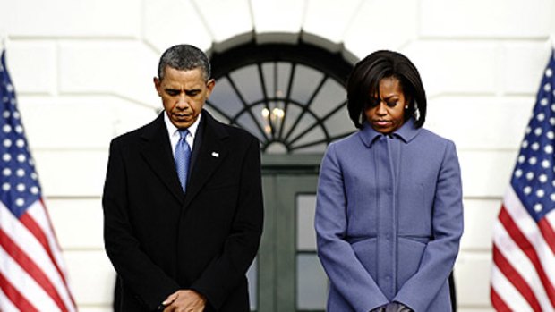 President Barack Obama and first lady Michelle Obama observe a 'moment of silence' on the South Lawn at the White House to honor victims of the Tucson shooting.