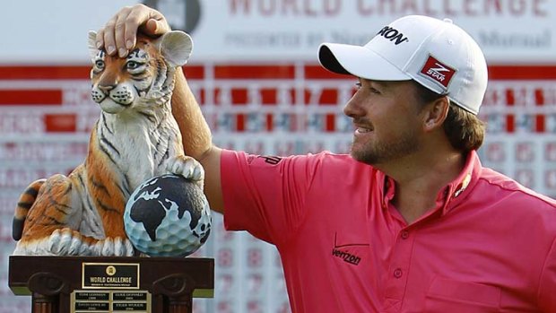 Graeme McDowell poses with his trophy after winning the World Challenge.