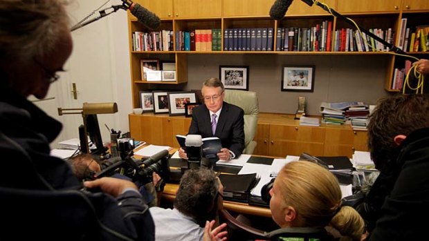 Tough times ... the Treasurer, Wayne Swan, poses with this year's budget papers.