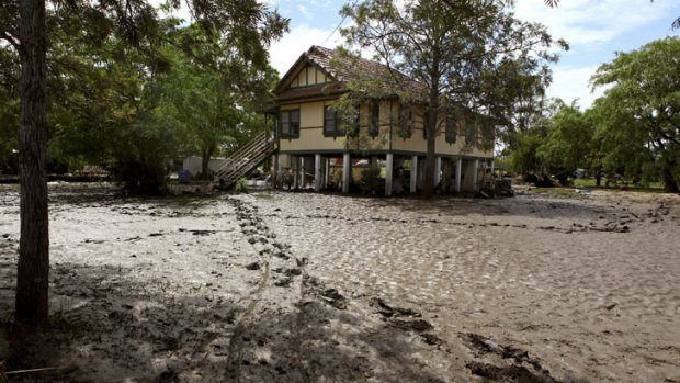 Silt and mud surrounds a home on Short Street, Laidley, where flood waters devastaed the town on Sunday.