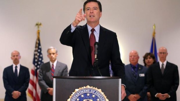 FBI Director James Comey takes a question during a news conference regarding James Foley.
