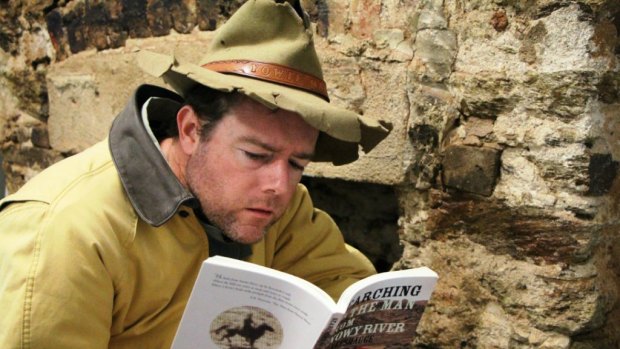 Tim the Yowie Man contemplates the plight of the Man from Snowy River in front of the very fireplace where Charlie McKeahnie died